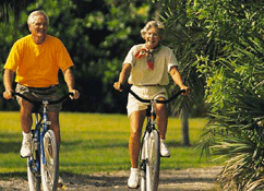 old couple on bikes 